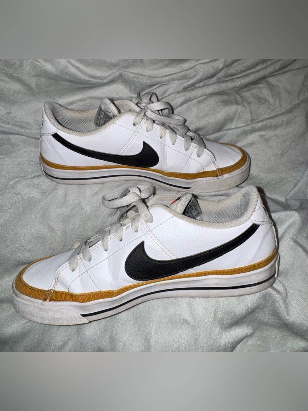 Nike White Sneakers with Black Swoosh and Gold Trim